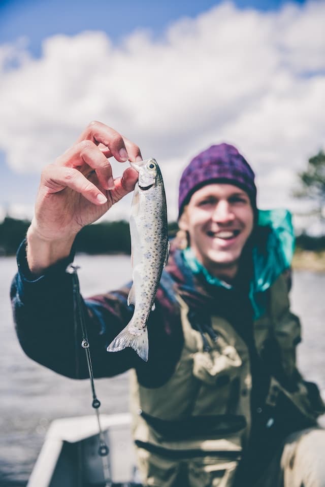 A Fisherman Who Caught a Small Gray Fish - Jakob Owens - From Unsplash
