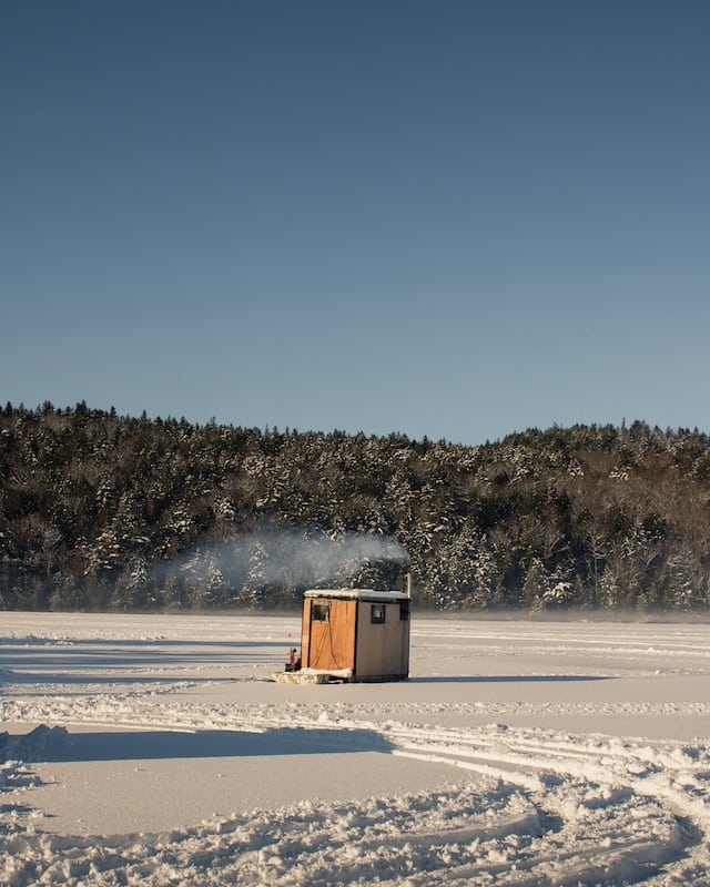 An Orange Cabin Heated - for Ice Fishing - on a Frozen Lake - Adam Bixby - From Unsplash