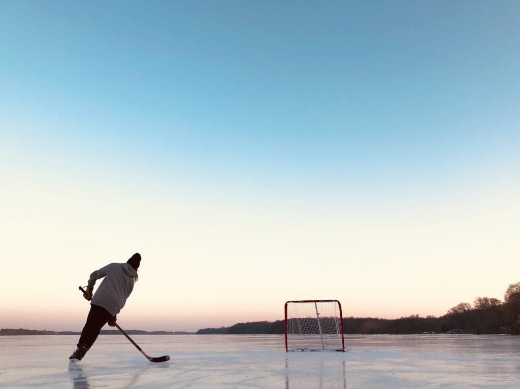 A Hockey Player - on a Frozen Lake - Taylor Friehl - From Unsplash