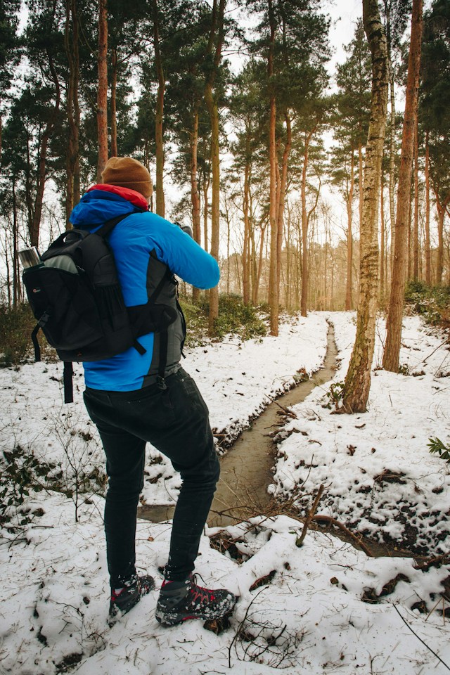 A Man with Studded Snow Boots - and a Winter Hat - Luke Porter - From Unsplash