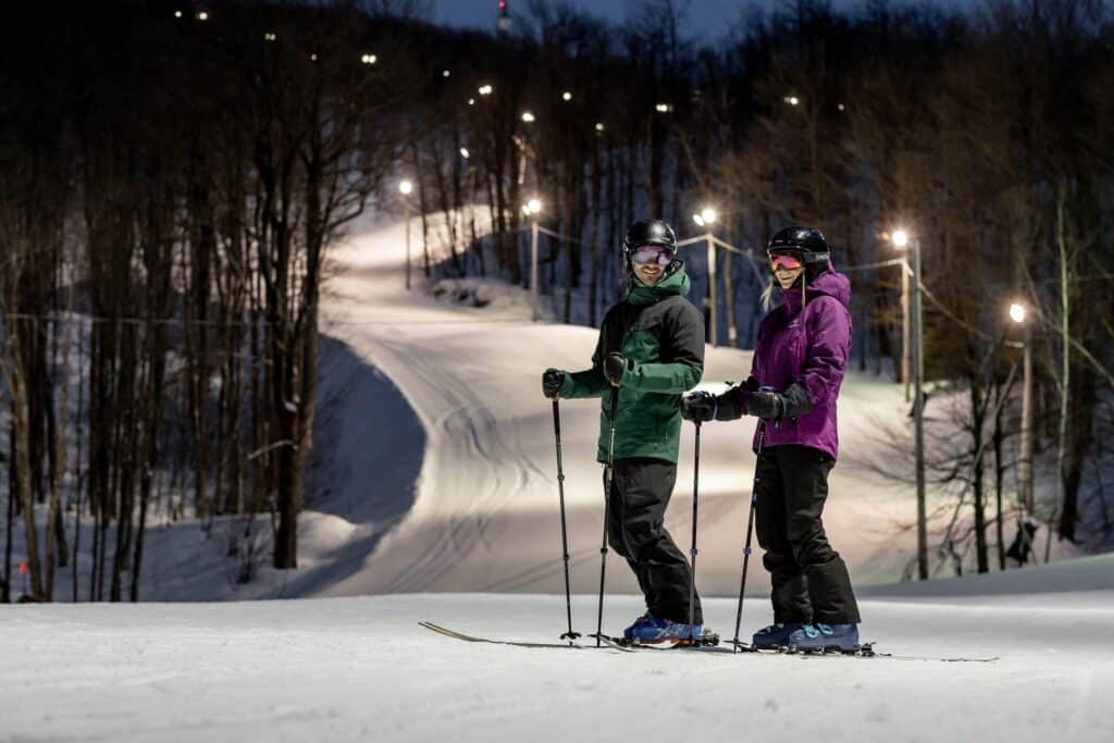 Couple Skiing in the Night - Bromont Montagne D'Experiences - Skiing the Eastern Townships
