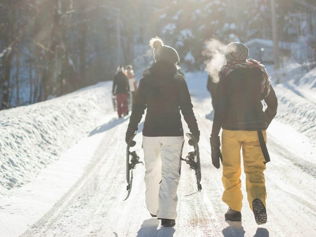 Two People - Preparing for a Snowshoe Hike - on a Sunny Day - Alain Wong - From Unsplash