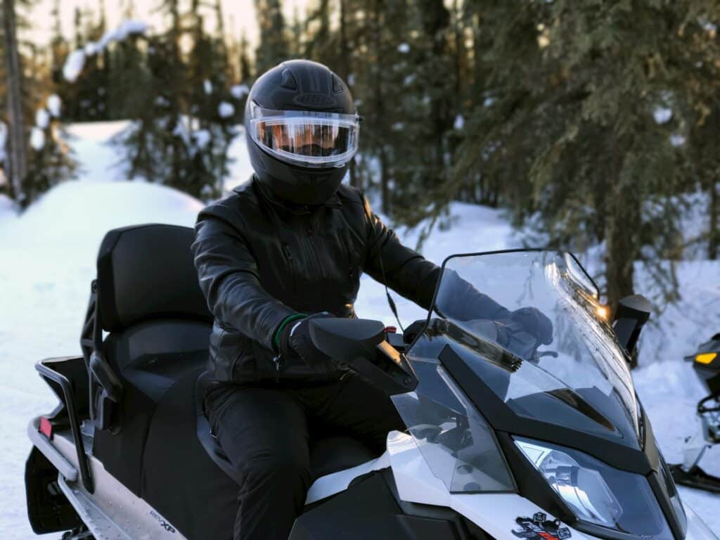 A Man with Helmet - on a Snowmobile - Qiuhai Gao - from Unsplash