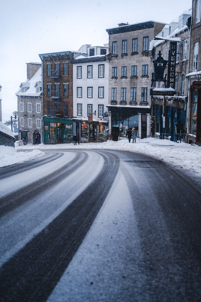 A Street with Snow on the Ground - and Buildings in the Background - Quebec City - Ryunosuke Kikuno - From Unsplash