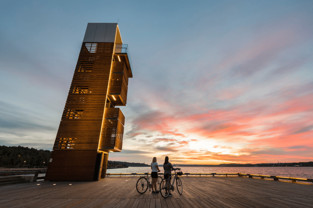 Jeff Frenette - Destination Quebec Cite - Two People on a Bike Break - Near a Tower Overlooking the St-Lawrence River