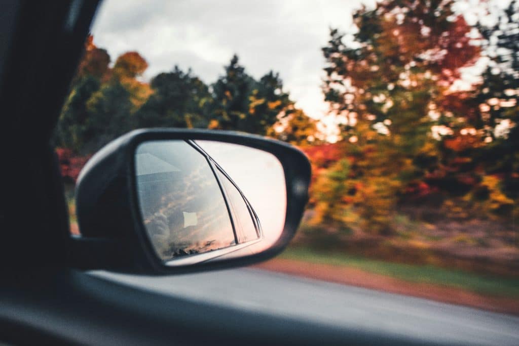 Car mirror on a fall roadtrip - Nathalia Segato - Unsplash