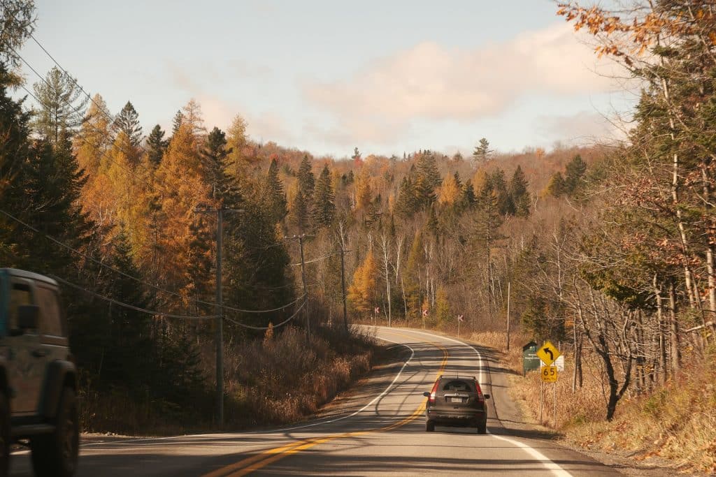 Car on a fall road between Ontario and Quebec - Naz Israyelyan - Unsplash